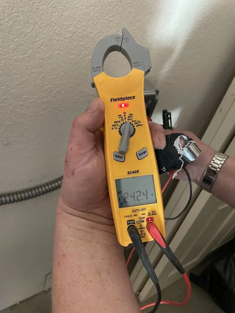 Voltage testing with clamp meter during Outlet Installation in Two Rivers